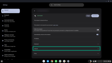 The arrow next to the Wi-FI network name in Settings highlighted.
